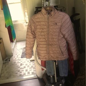 This is a reversible North Face dusty rose winter jacket